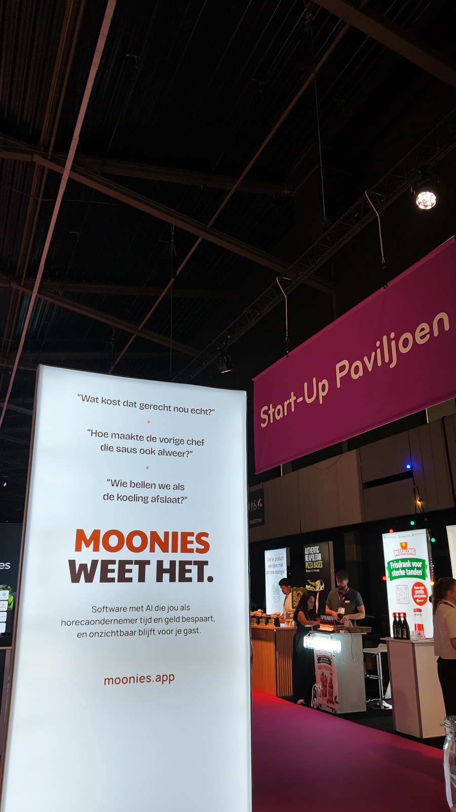 The illuminated moonies banner at Gastvrij Rotterdam, with the Start-Up Pavilion sign in Ahoy behind it.